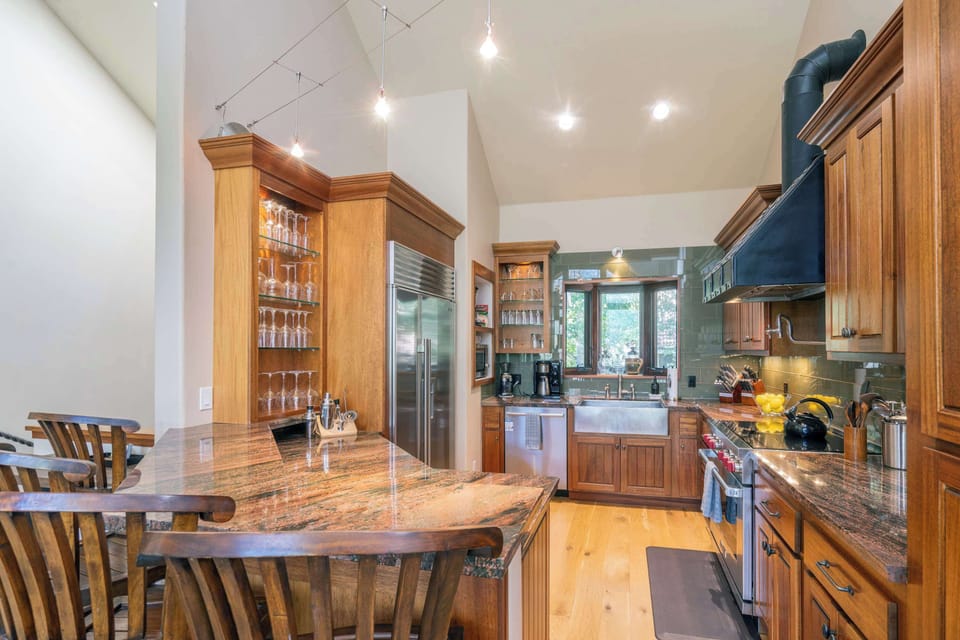 Kitchen: Wolf Induction Range, Hexclad pots and pans, Ninja drip coffee maker, Crockpot, blender, kettle, food processor, cooking utensils, tableware
