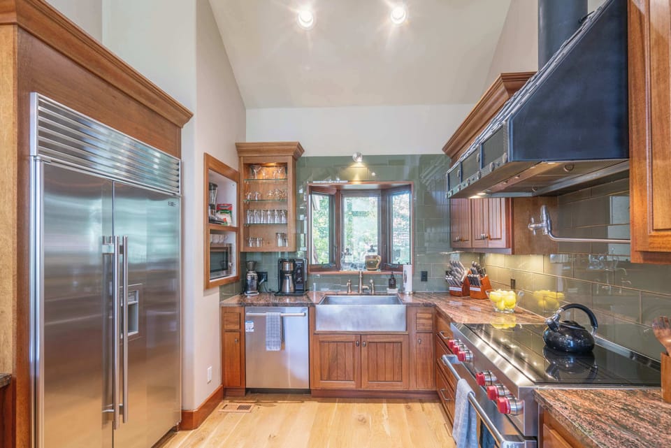 Kitchen: Wolf Induction Range, Hexclad pots and pans, Ninja drip coffee maker, Crockpot, blender, kettle, food processor, cooking utensils, tableware