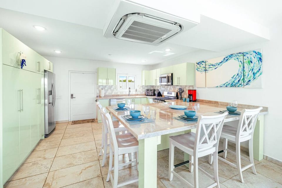 Get ready to entertain in style! This chic kitchen bar is perfect for casual bites and lively conversations, all while enjoying the fresh coastal vibe. Let the good times roll!