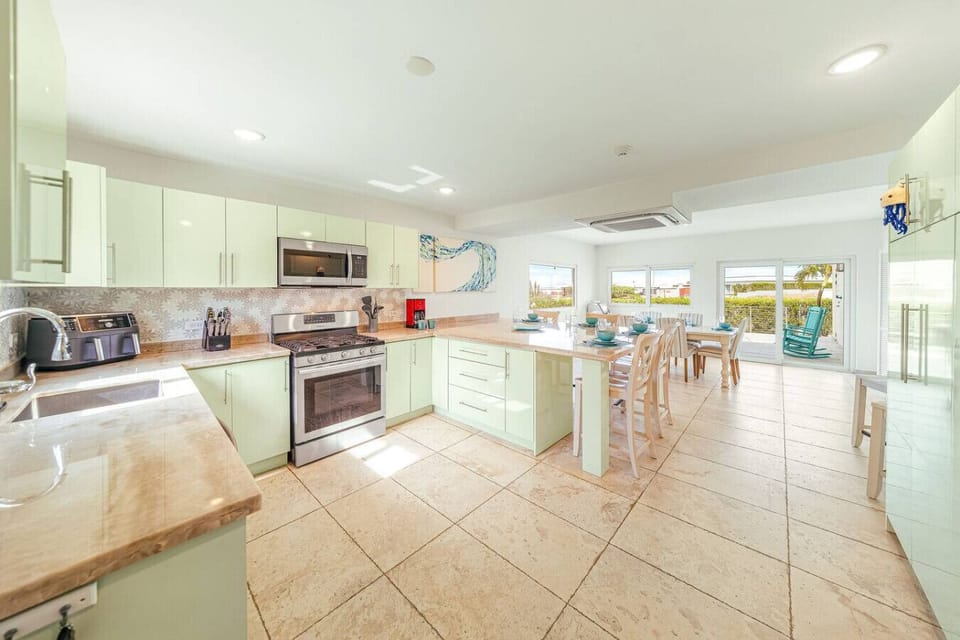 Gather in this bright and breezy kitchen! Whether you’re whipping up a feast or sharing stories over coffee, this space is all about good times and great flavors.