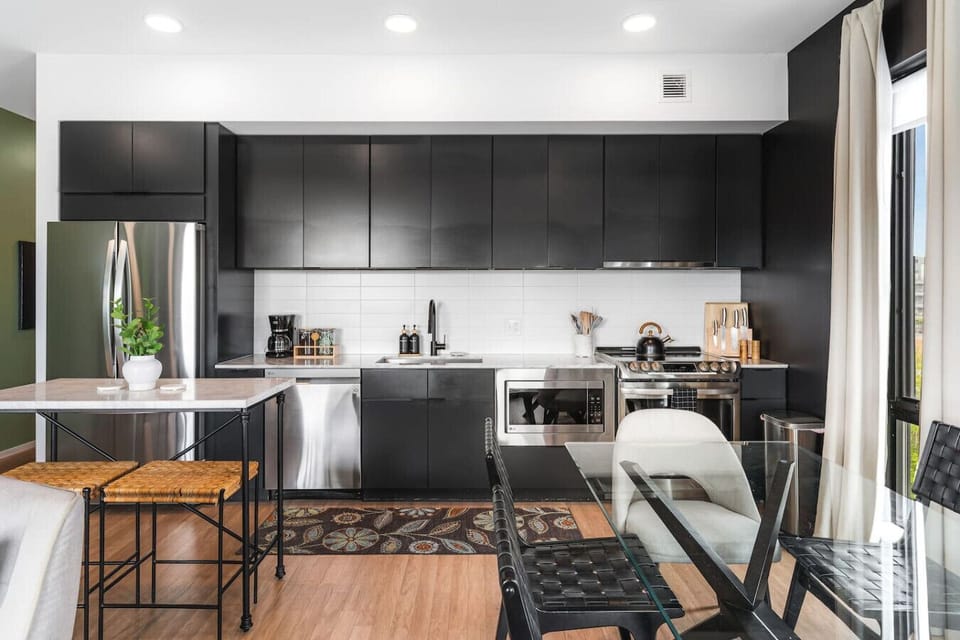 Our kitchen is fully equipped with high-end appliances and two dining areas. Private balcony off of this area to enjoy your morning coffee.