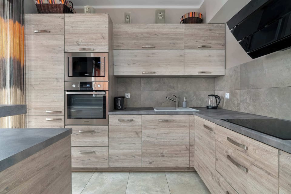 A modern kitchen with built-in appliances and a spacious countertop provides comfort when preparing meals.