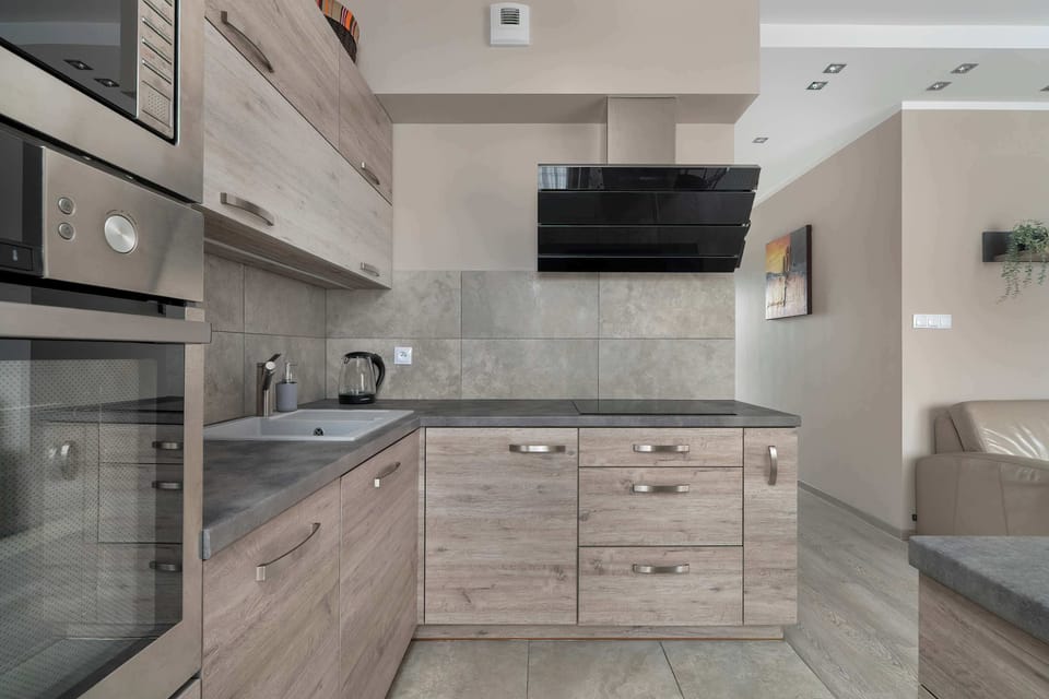 A functional kitchen with plenty of cabinets and a bright countertop provides comfort for cooking and storing groceries.