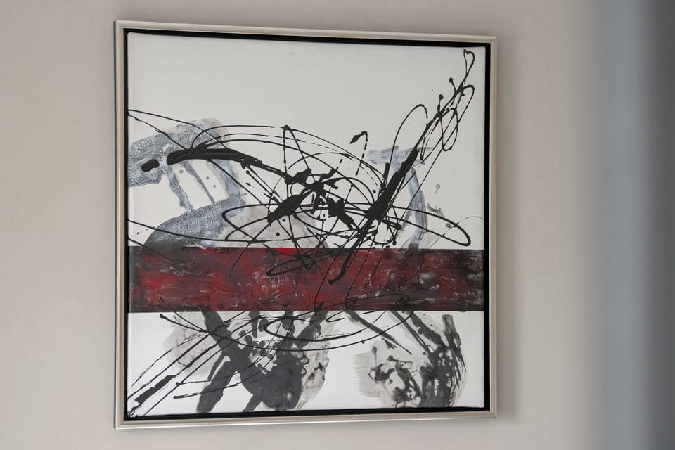 An abstract painting adds character and an artistic touch to the interior.
