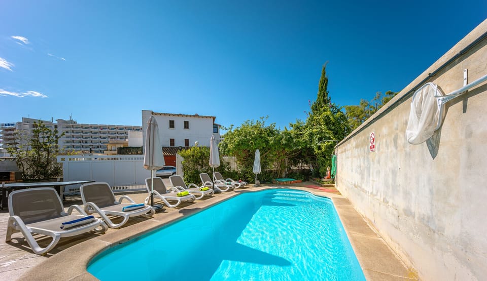 Private pool at Casa Luna in Puerto de Alcudia with sun loungers and terrace area, perfect for enjoying summer holidays in Mallorca close to the beach.