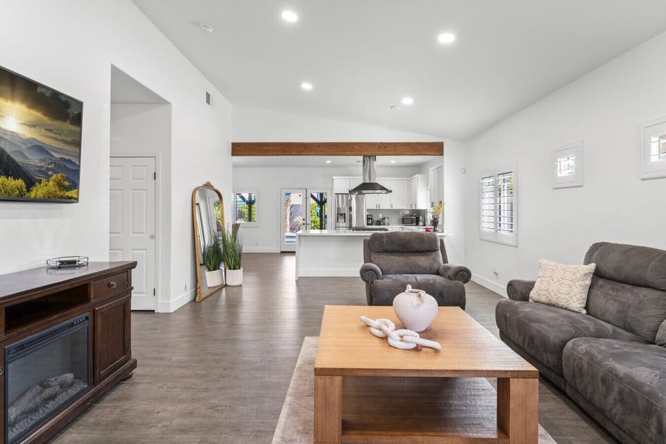 Open living & kitchen area w/ large sectional and wall-mounted TV for cozy nights in.
