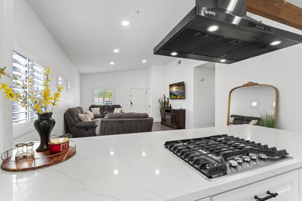 Bright kitchen island w/ gas cooktop & open sightlines to the living area.