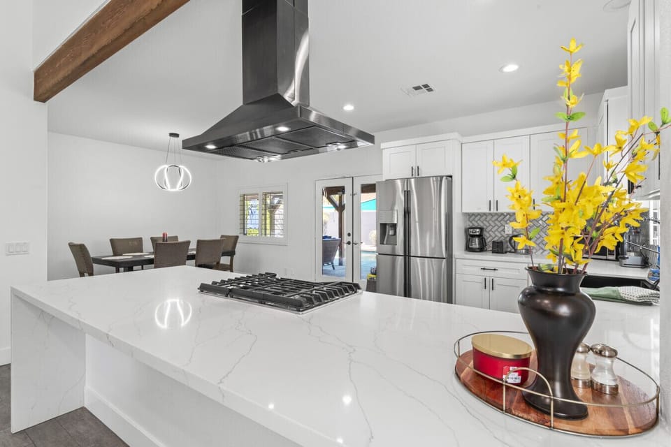 Spacious kitchen w/ large island, stainless hood & bar seating for casual bites.