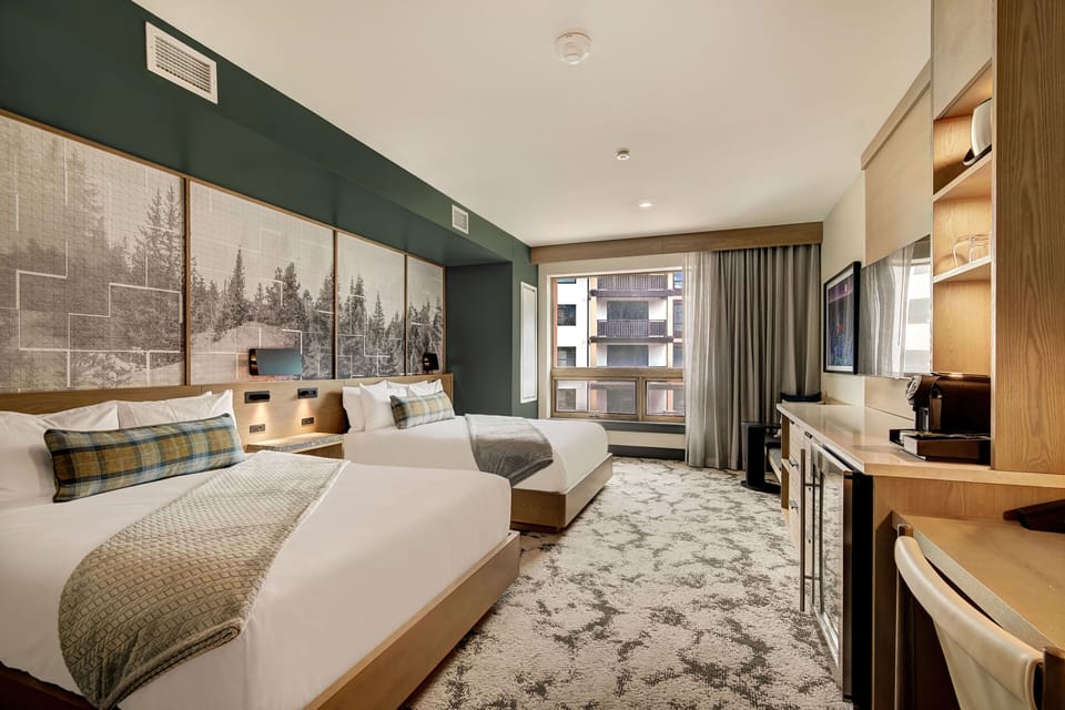 Cozy queen room with warm alpine décor and a workspace
