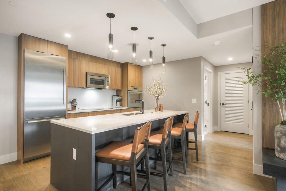 Open-plan kitchen flowing seamlessly into the living area — pour drinks at the island and carry the conversation through