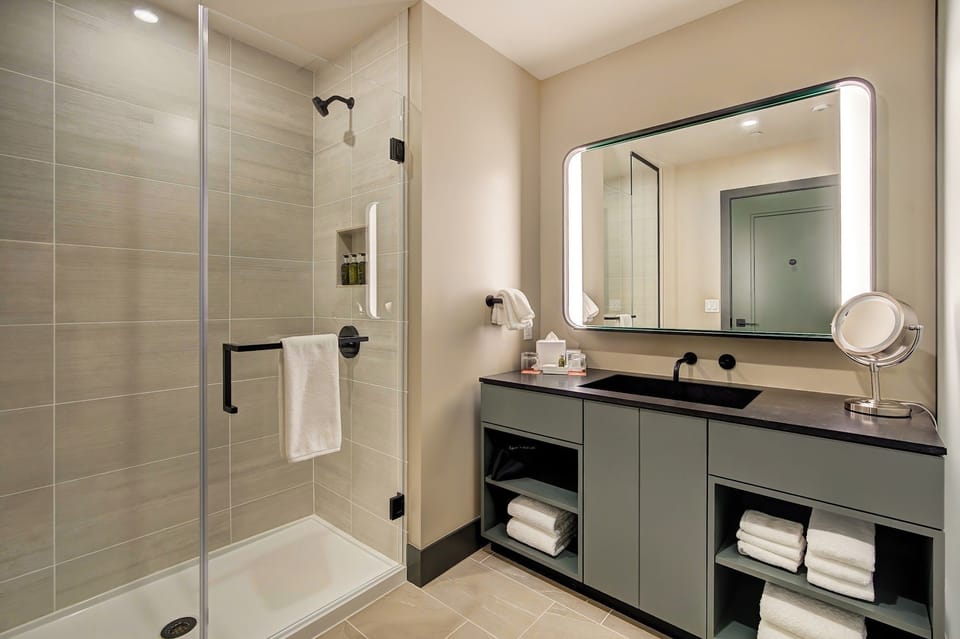 Modern glass shower, sleek vanity, and bright mirror — refreshed and ready for the slopes