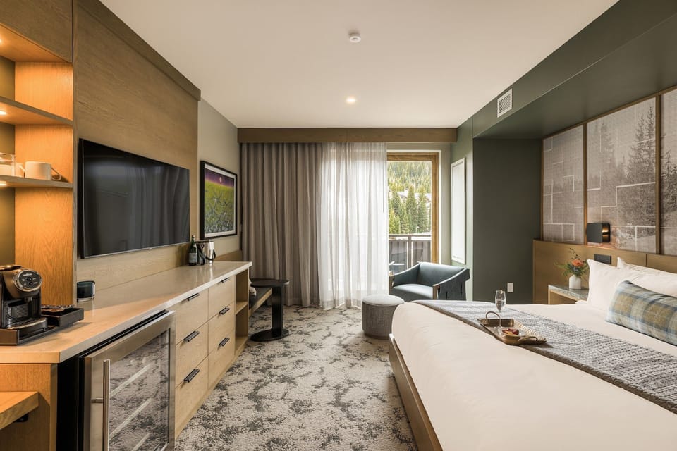 King bed, coffee maker, and curtains drawn soft — mornings here move at their own mountain pace