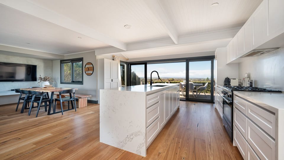 Kitchen and dining, leading out to balcony 