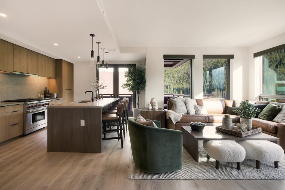 Open-concept living area with mountain backdrops and comfortable, stylish seating