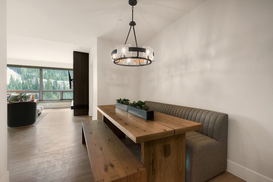 Welcoming dining space bathed in natural light beneath a modern chandelier