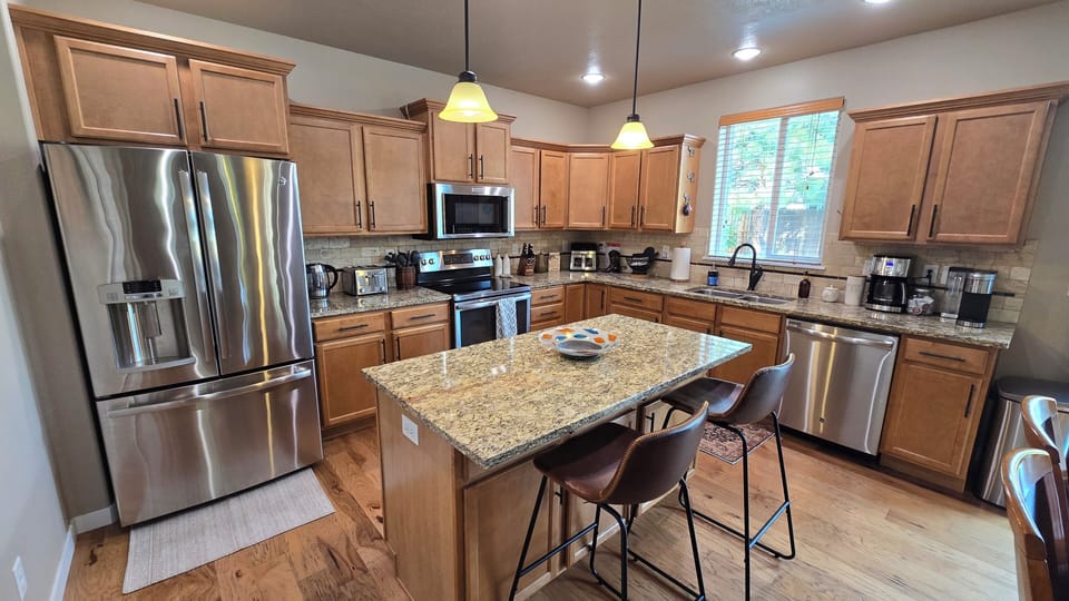 Fully stocked kitchen with many appliances and cooking supplies for every meal.