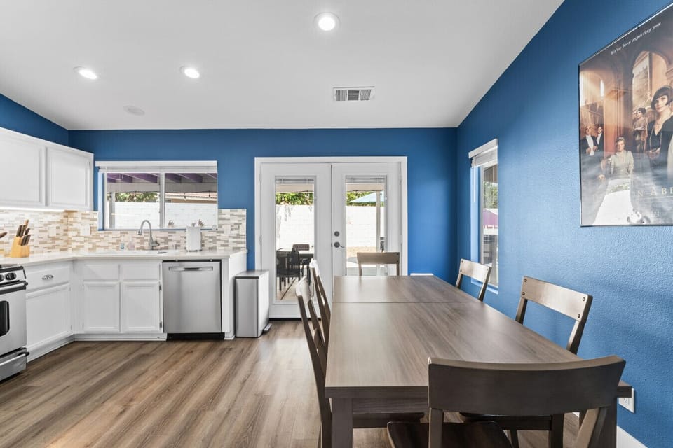 Open dining area w/ blue accent walls & easy flow into the bright kitchen.