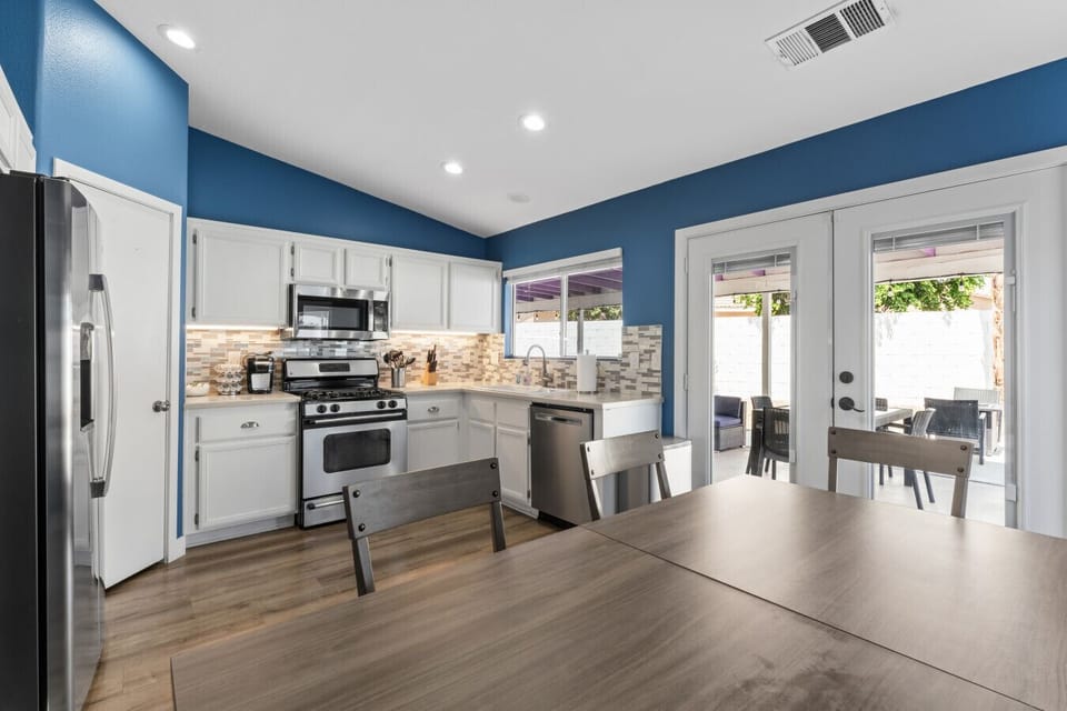 Spacious kitchen w/ stainless appliances, bar seating & backyard access.