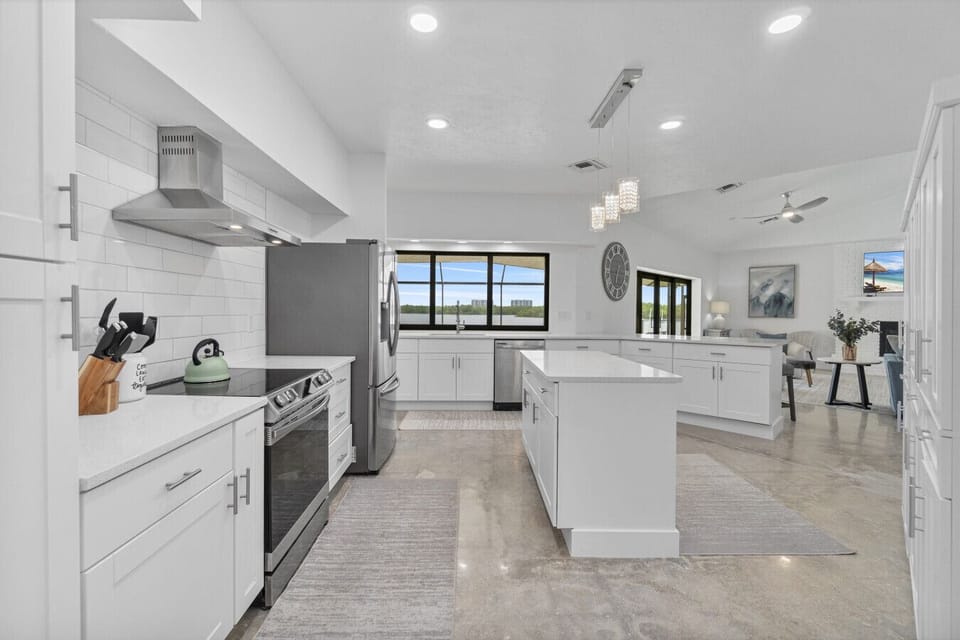 Cook with ease in the modern, fully stocked kitchen with island seating.