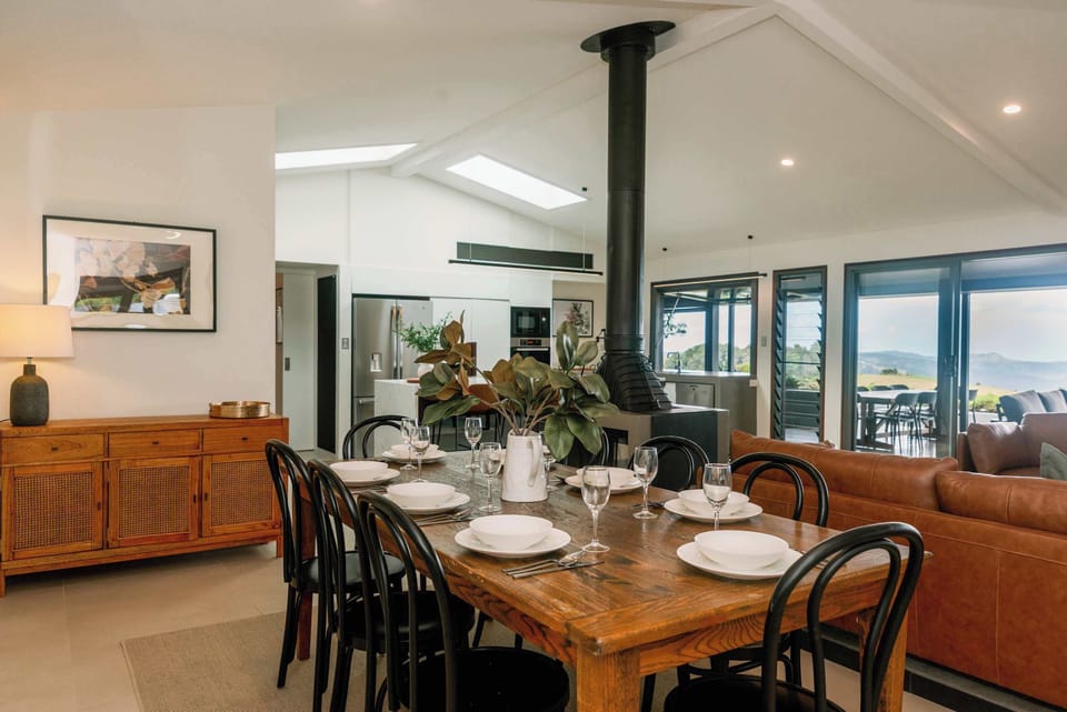 A warm dining space with a rustic wooden table, seating for eight, and a cozy atmosphere perfect for family meals.