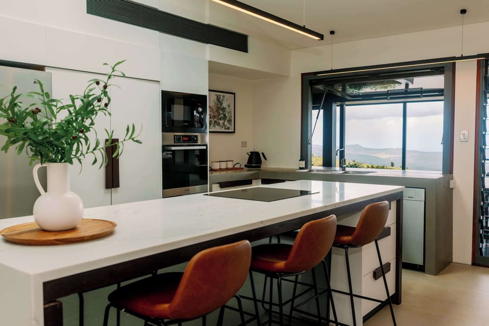 Stylish full kitchen with contemporary finishes, high-end fridge, and built-in oven for convenience.