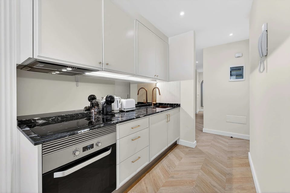 Sleek Marble Kitchen and Designer Fixtures – Cook and Dine in Style with Gold Accents and Luxe Appliances