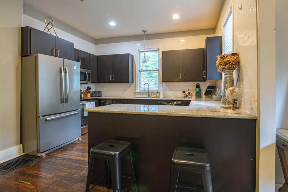 Modern design with sleek appliances and a sunny view for tasty culinary adventures!