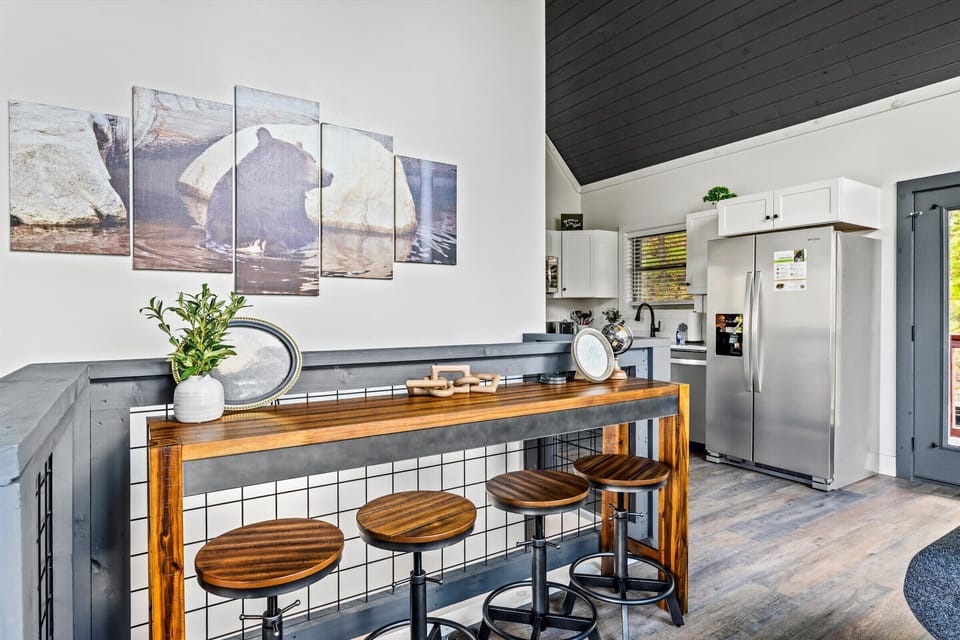 Fully equipped kitchen features a convenient breakfast bar with stylish seating, perfect for casual dining or entertaining. Modern appliances and ample counter space make meal preparation a breeze. 