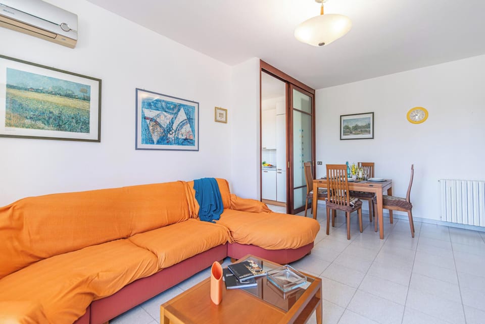 Family Apartment, Multiple Bedrooms (Casa Gialla) | Living area | 21-inch TV with cable channels