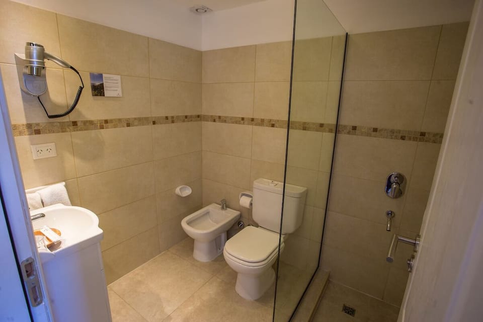 Refresh in a sleek walk-in shower with warm lighting.