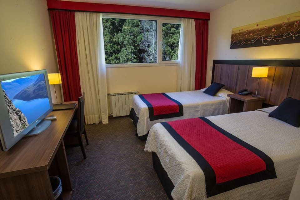 Relax together in comfortable twin beds with soft bedside lamps.