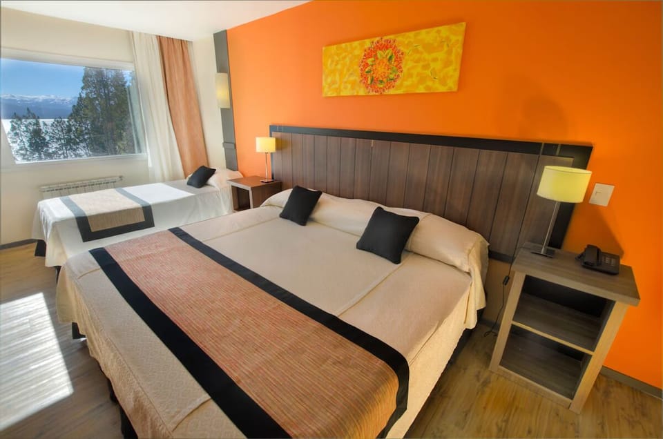 Sink into a spacious bed with warm, sunset-toned décor.