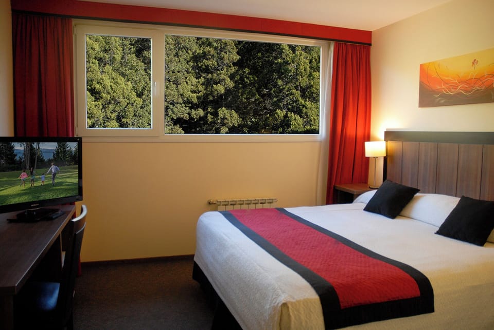 Unwind in a cozy room with calming forest views.