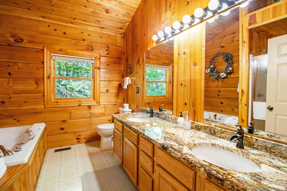En suite bathroom includes double vanity, jetted tub, and shower