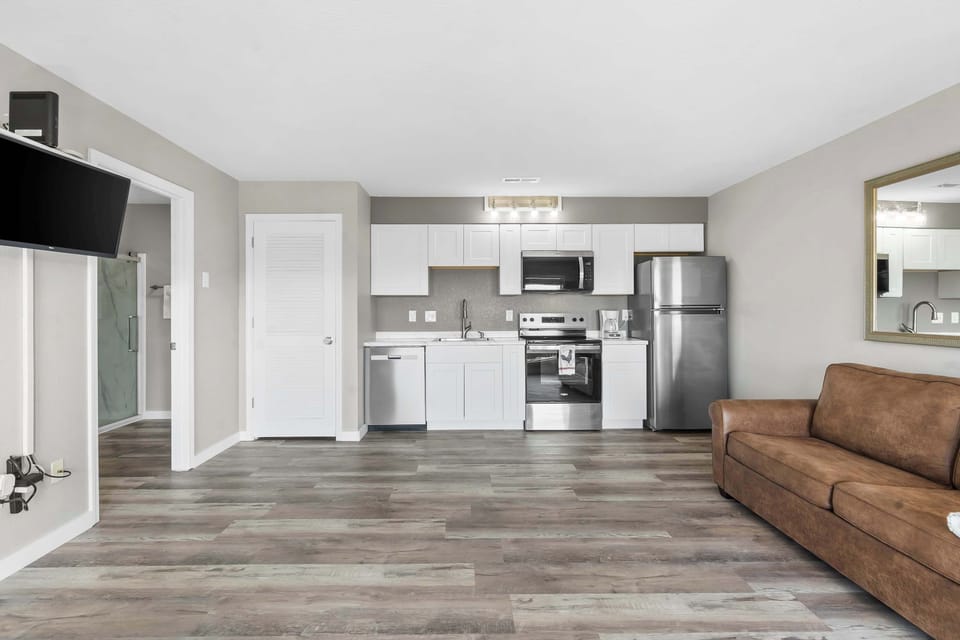 The sleek, open kitchen offers ample space & every home comfort​