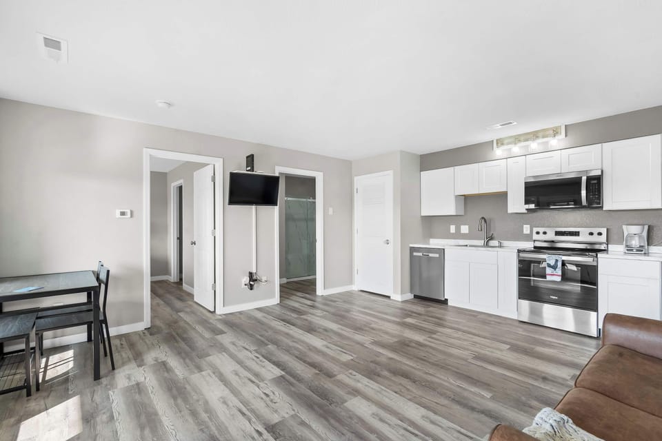 The sleek, open kitchen offers ample space & every home comfort​