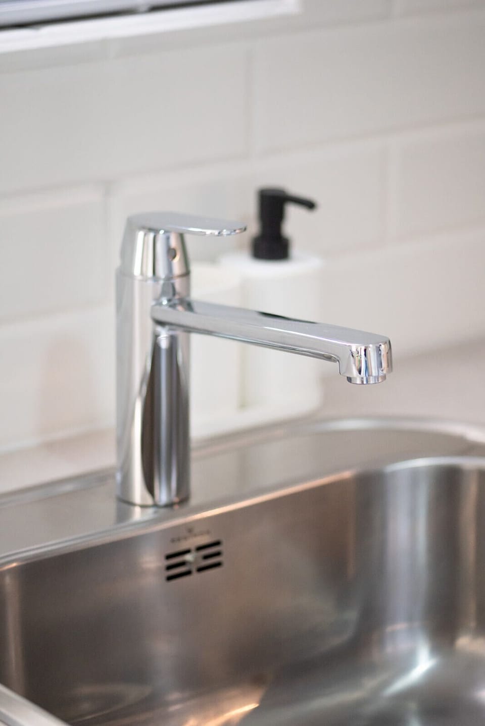 Modern kitchen sink with sleek chrome faucet.