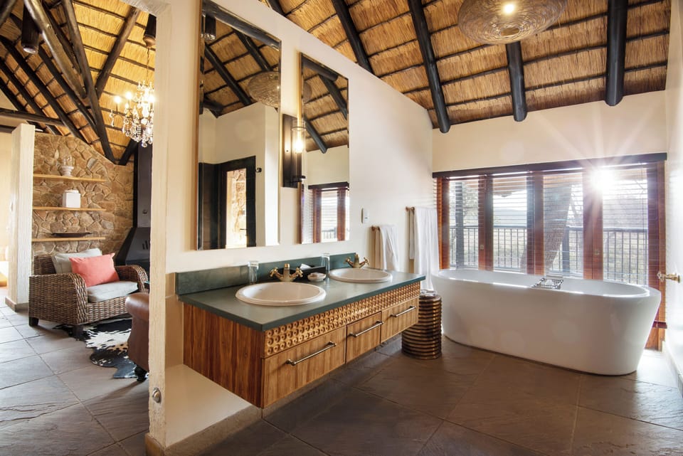 Tshukudu Executive Suite | Bathroom | Designer toiletries, hair dryer, bathrobes, slippers