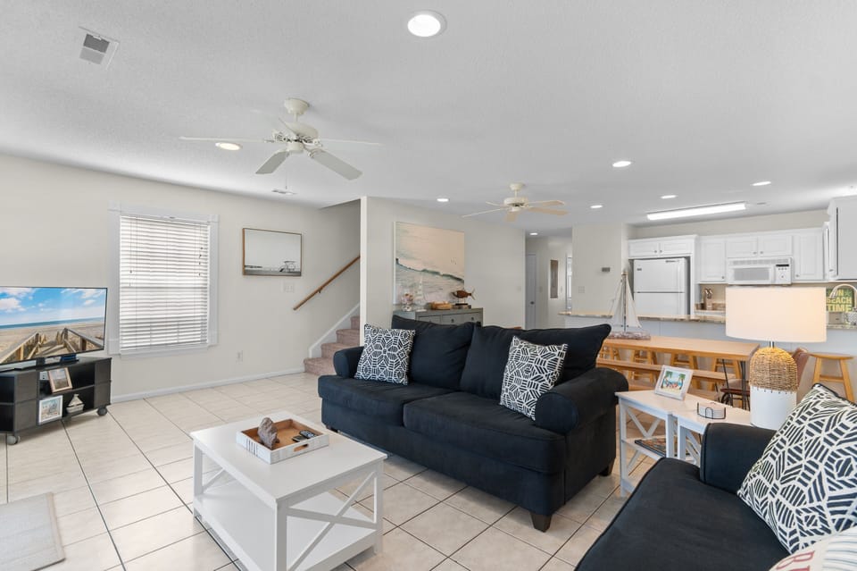 Relax in your bright, open living space with plush seating, coastal touches, and a fully equipped kitchen for memorable meals together.