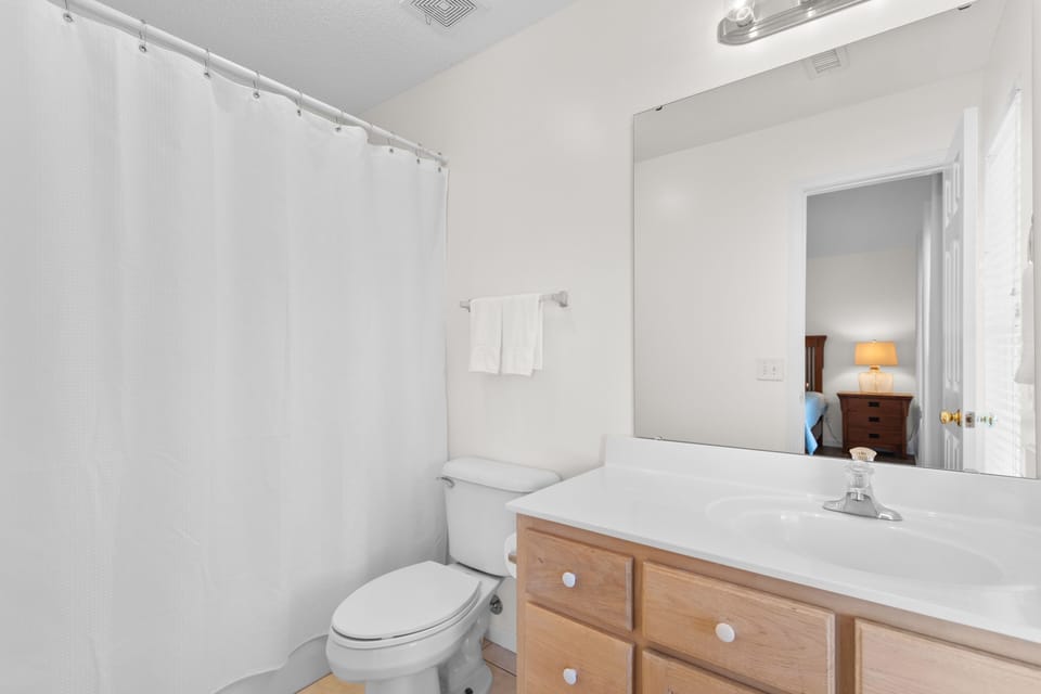 Your private bathroom features a convenient tub-shower combo and vanity with ample storage for all your essentials.