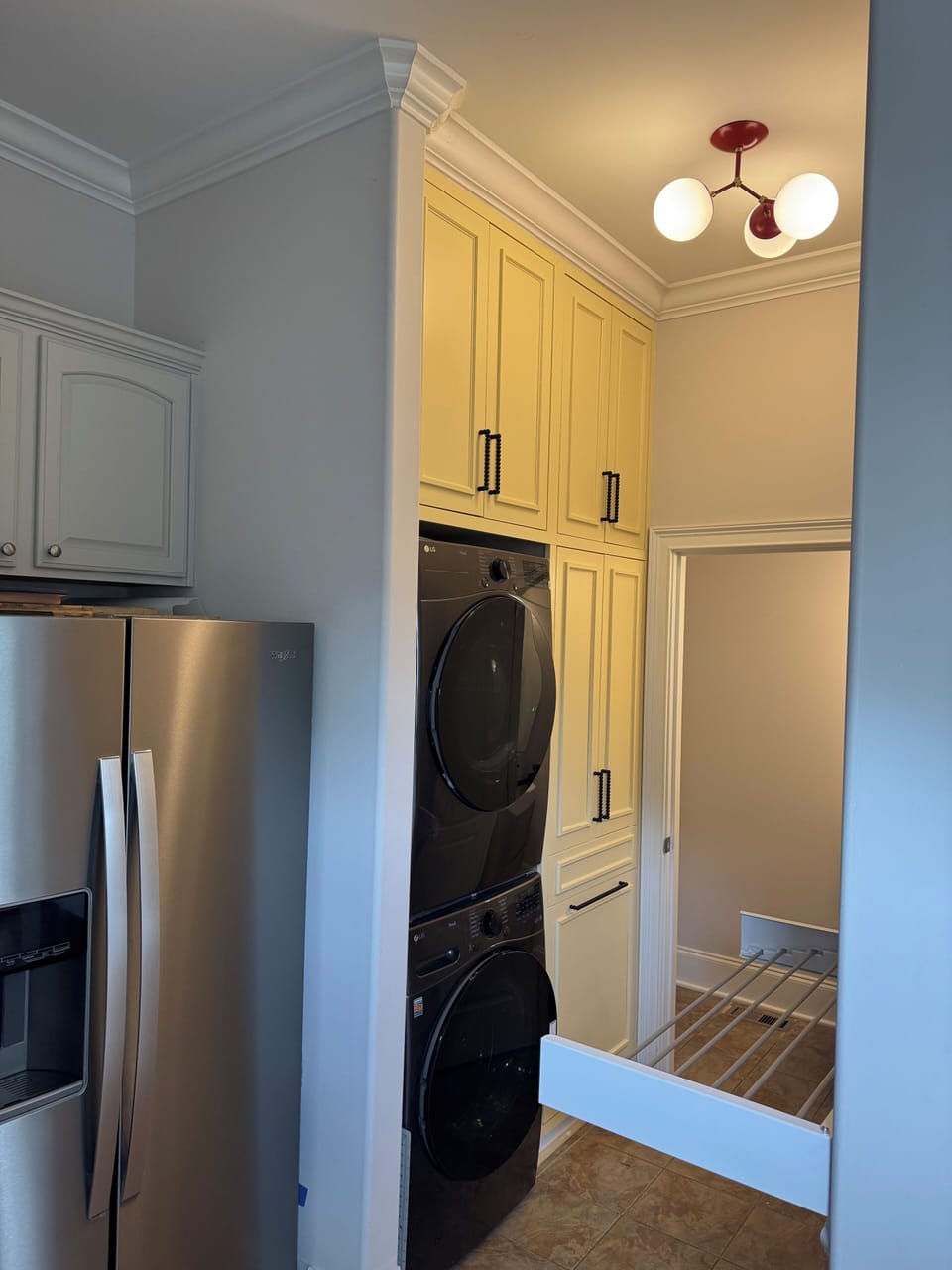Large capacity washer/dryer, hall leads to half bath.