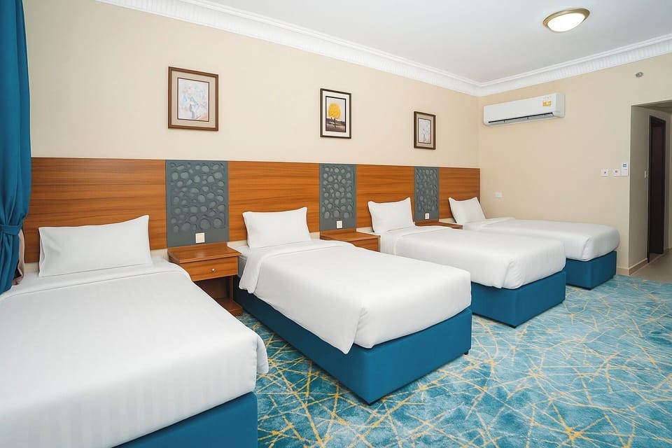 Deluxe Quadruple Room | Hypo-allergenic bedding, minibar, desk, laptop workspace