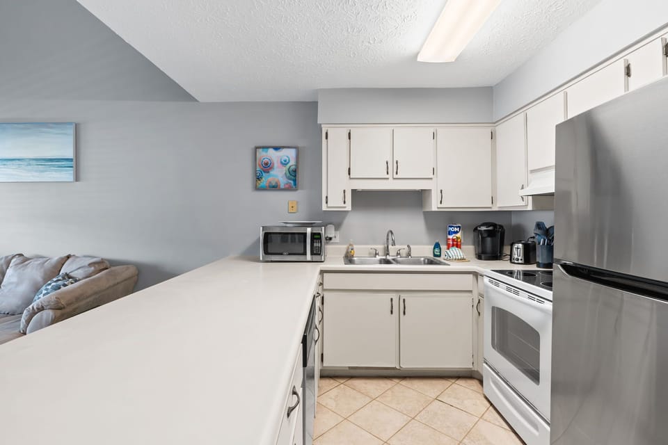 Outfitted with modern appliances—including a full-size refrigerator, stove, microwave, and coffee maker—it's equipped with all the essentials for meal prep