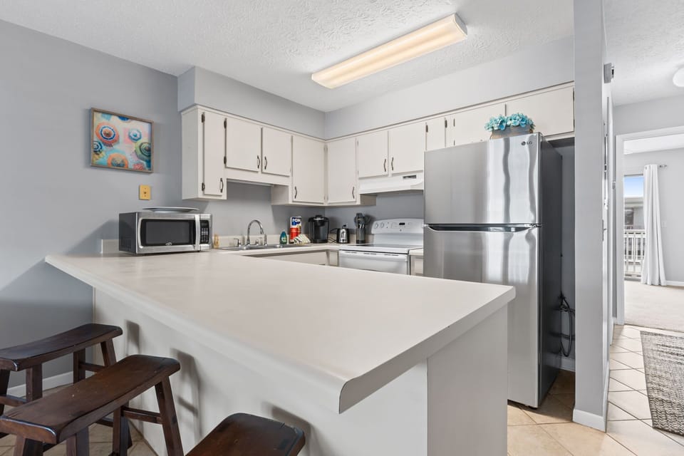 Thoughtfully stocked with cookware, utensils, and dinnerware, the space is designed for convenience and comfort.