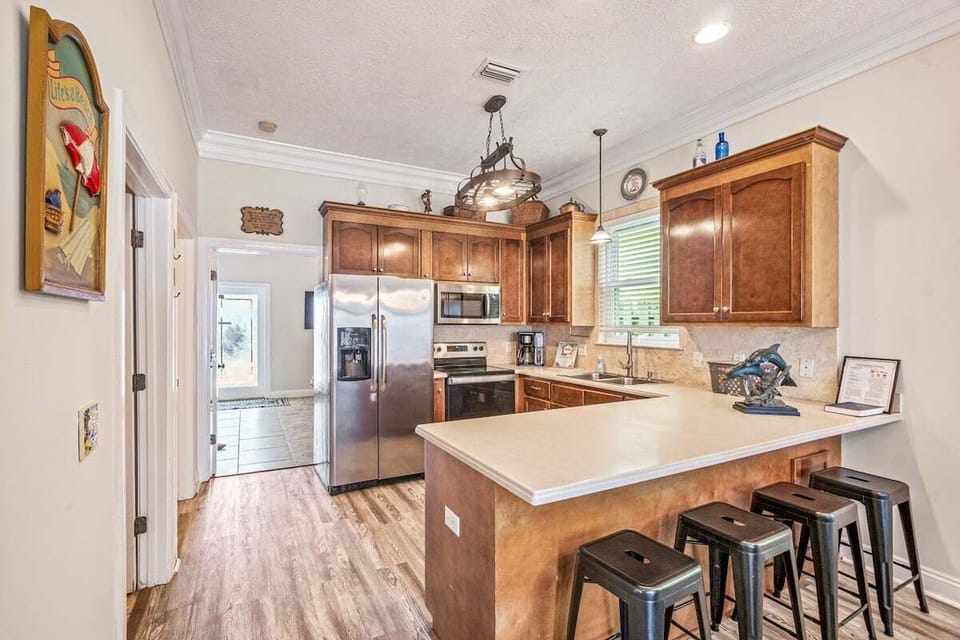 Stylish kitchen on the first floor equipped with stainless steel appliances and a handy breakfast bar with easy access to whole house!