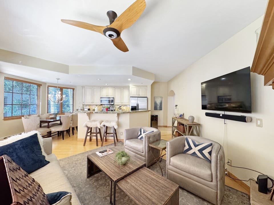 Open floorplan view showing kitchen island, dining area, and full kitchen - perfect layout where everyone stays connected whether cooking, eating, or relaxing nearby.