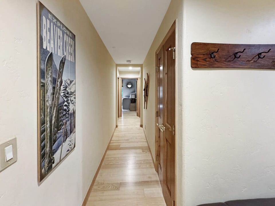 Where this hallway ends, two peaceful bedrooms await. Coat hangers by the entrance welcome you home, the perfect separation between lively common areas and quiet bedtime rooms