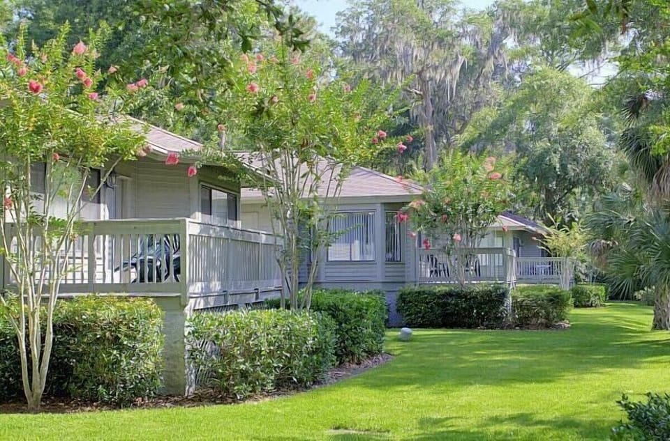 Arrive to a peaceful, tree-lined retreat with private porches.