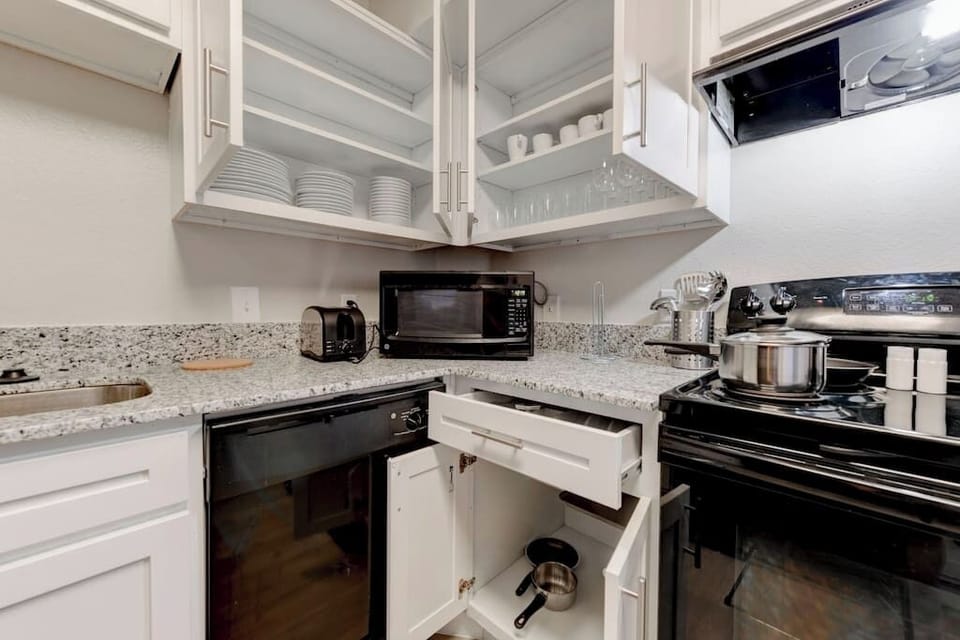 Kitchen prep area w/ stainless appliances & generous storage