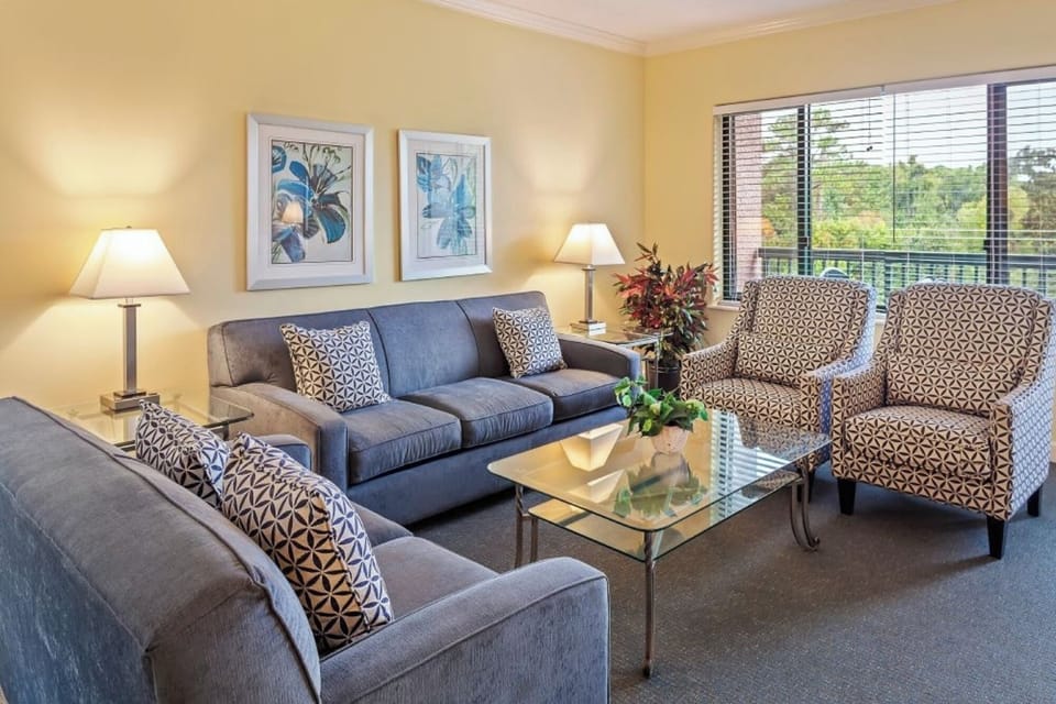 Relax in the sunlit lounge with plush seating and views.